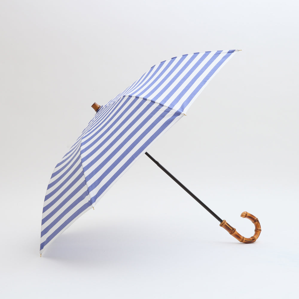 ブランドを代表するアイテム折りたたみ傘。撥水加工とUV加工を施して晴雨兼用としてお使い頂けます。  マテリアル：綿100％　原産国：日本